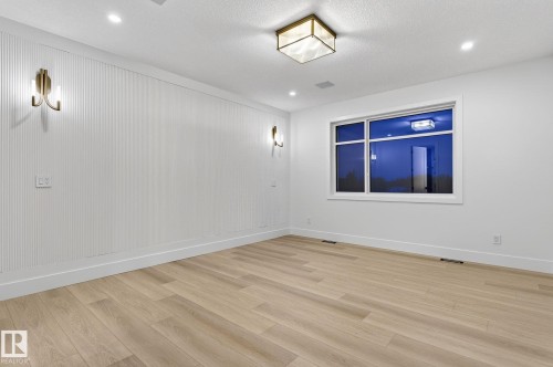 Empty room featuring baseboards and light wood-type flooring - 8765 Mayday Lane, Edmonton, AB - Indoor Photo Showing Other Room