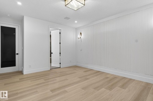 Unfurnished bedroom featuring baseboards and light wood-style floors - 8765 Mayday Lane, Edmonton, AB - Indoor Photo Showing Other Room