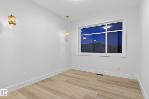 Spare room featuring light wood-type flooring and baseboards - 8765 Mayday Lane, Edmonton, AB - Indoor Photo Showing Other Room
