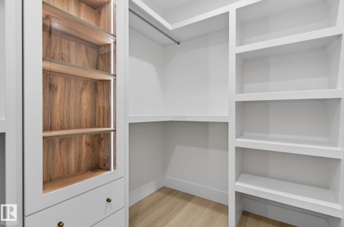 Walk in closet featuring light wood finished floors - 8765 Mayday Lane, Edmonton, AB - Indoor With Storage