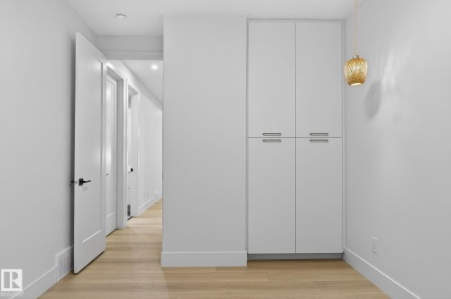 Unfurnished bedroom featuring light wood-style floors and a closet - 8765 Mayday Lane, Edmonton, AB - Indoor Photo Showing Other Room