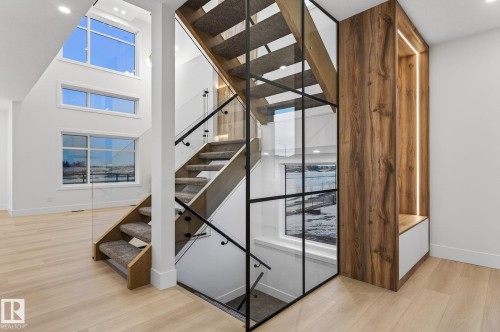 Staircase featuring wood finished floors, a high ceiling, and recessed lighting - 8765 Mayday Lane, Edmonton, AB - Indoor Photo Showing Other Room