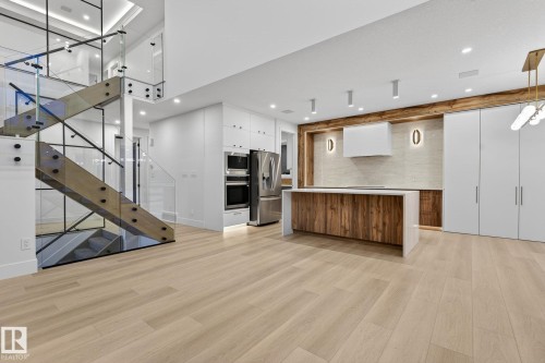 Unfurnished living room with light wood finished floors and recessed lighting - 8765 Mayday Lane, Edmonton, AB - Indoor