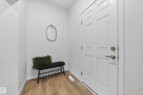 Foyer entrance featuring baseboards and light wood-style floors - 20723 24 Avenue, Edmonton, AB - Indoor Photo Showing Other Room