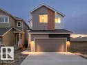 Modern home with board and batten siding, driveway, an attached garage, and stone siding - 20723 24 Avenue, Edmonton, AB  - Outdoor 