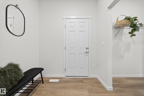 Foyer with light wood-type flooring and baseboards - 20723 24 Avenue, Edmonton, AB - Indoor Photo Showing Other Room