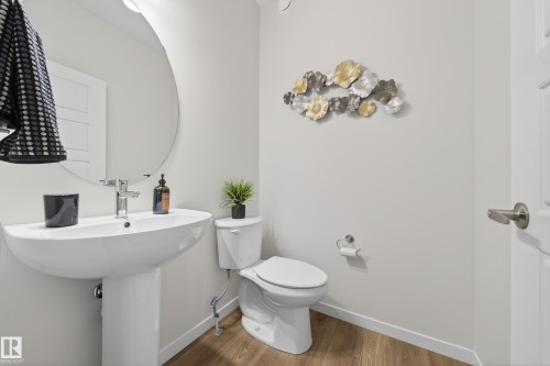 Half bath with toilet and light wood-style floors - 20723 24 Avenue, Edmonton, AB - Indoor Photo Showing Bathroom