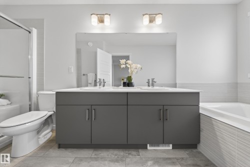 Bathroom with a bath, double vanity, and a shower stall - 20723 24 Avenue, Edmonton, AB - Indoor Photo Showing Bathroom