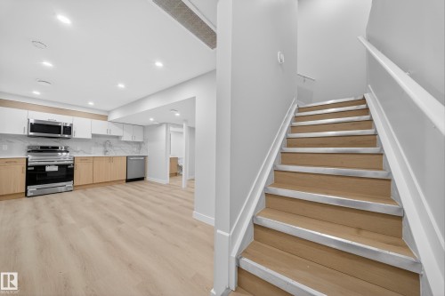 Staircase featuring wood finished floors and recessed lighting - 20723 24 Avenue, Edmonton, AB - Indoor