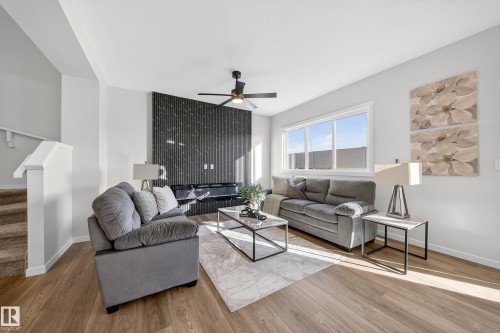 Living room with a ceiling fan and wood finished floors - 20723 24 Avenue, Edmonton, AB - Indoor Photo Showing Living Room