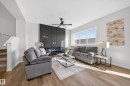 Living room with a ceiling fan and wood finished floors - 20723 24 Avenue, Edmonton, AB  - Indoor Photo Showing Living Room 