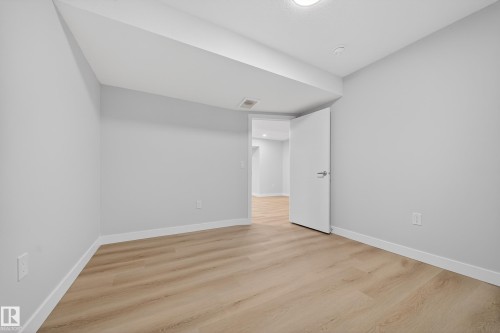 Empty room featuring light wood finished floors and baseboards - 20723 24 Avenue, Edmonton, AB - Indoor Photo Showing Other Room
