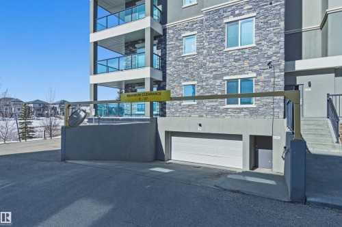 View of property with a garage and driveway - 106 1238 Windermere Way, Edmonton, AB - Outdoor With Balcony