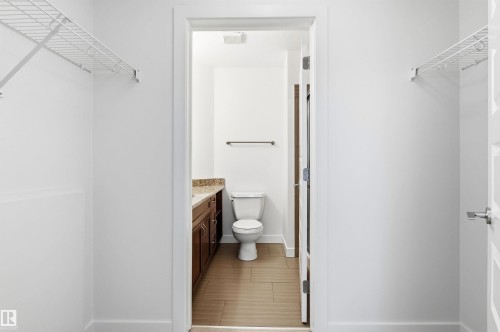 Bathroom featuring vanity and toilet - 106 1238 Windermere Way, Edmonton, AB - Indoor Photo Showing Bathroom