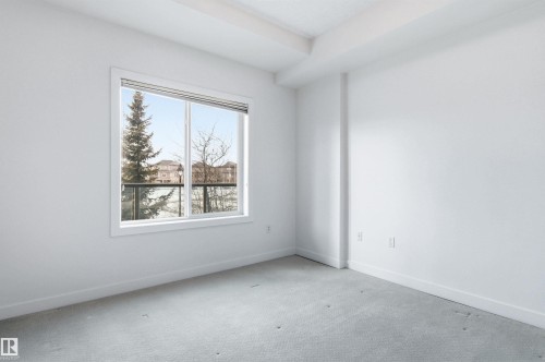 Spare room featuring baseboards and carpet flooring - 106 1238 Windermere Way, Edmonton, AB - Indoor Photo Showing Other Room