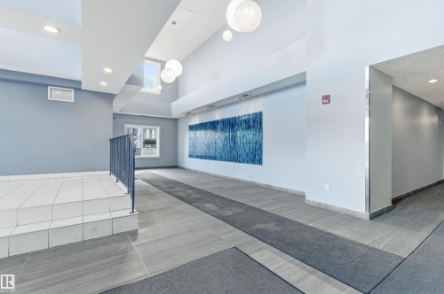 Community lobby with a high ceiling and recessed lighting - 106 1238 Windermere Way, Edmonton, AB - Indoor Photo Showing Other Room