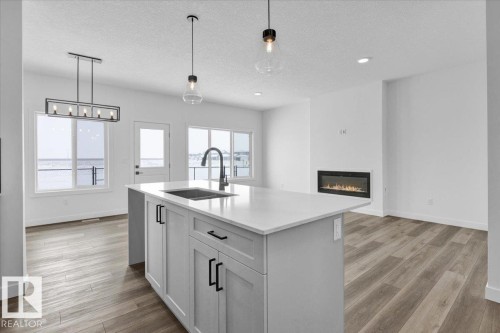 61 Sumac Close, Fort Saskatchewan, AB - Indoor Photo Showing Kitchen With Fireplace