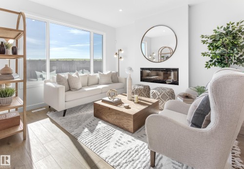 713 Payipwat Common, Edmonton, AB - Indoor Photo Showing Living Room With Fireplace