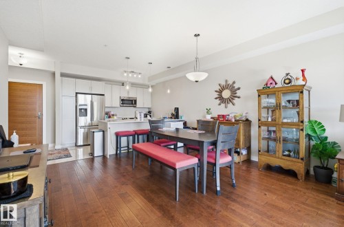 Dining space featuring dark wood-style floors - 309 625 Leger Way, Edmonton, AB - Indoor