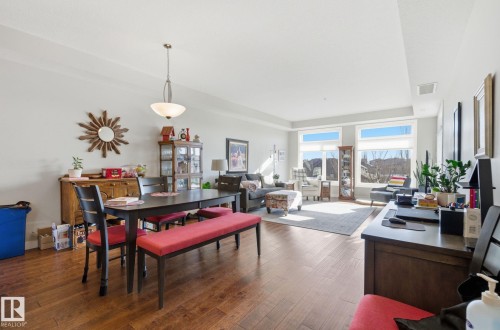 Dining room with dark wood-style floors and baseboards - 309 625 Leger Way, Edmonton, AB - Indoor Photo Showing Other Room