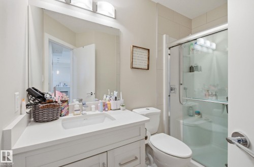 Bathroom with vanity and a stall shower - 309 625 Leger Way, Edmonton, AB - Indoor Photo Showing Bathroom