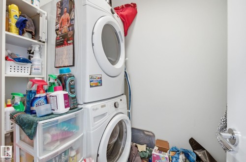 Laundry area with stacked washer / drying machine - 309 625 Leger Way, Edmonton, AB - Indoor Photo Showing Laundry Room