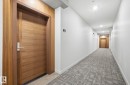 Hallway featuring light colored carpet and recessed lighting - 309 625 Leger Way, Edmonton, AB  - Indoor Photo Showing Other Room 