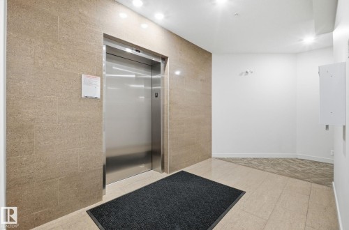 Full bathroom with elevator, a shower stall, and recessed lighting - 309 625 Leger Way, Edmonton, AB - Indoor Photo Showing Other Room