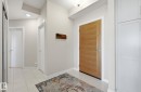 Foyer with light tile patterned floors and recessed lighting - 309 625 Leger Way, Edmonton, AB  - Indoor Photo Showing Other Room 