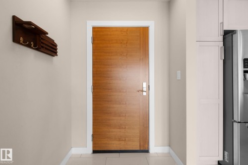 Solid wood-panel door with brushed nickel hardware - 309 625 Leger Way, Edmonton, AB - Indoor