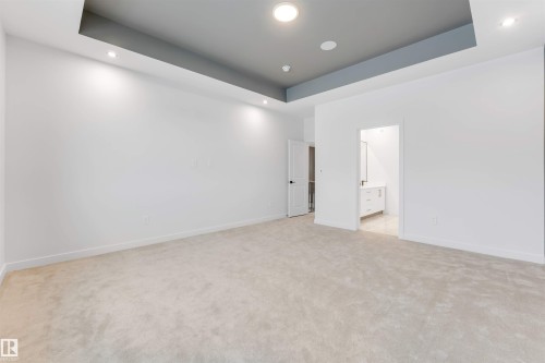 Empty room with a tray ceiling, recessed lighting, and light colored carpet - 13 Trill Point(E), Spruce Grove, AB - Indoor Photo Showing Other Room