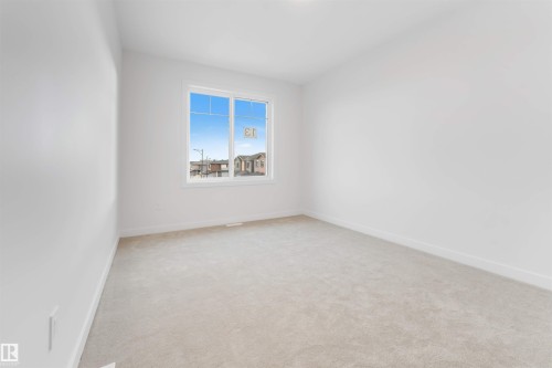Unfurnished room with baseboards and light colored carpet - 13 Trill Point(E), Spruce Grove, AB - Indoor Photo Showing Other Room