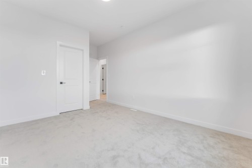 Spare room with baseboards and light carpet - 13 Trill Point(E), Spruce Grove, AB - Indoor Photo Showing Other Room