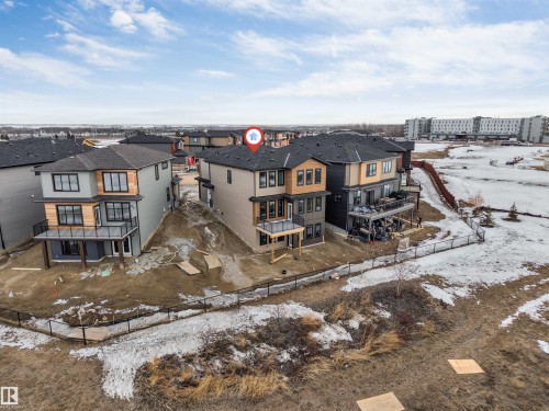 Snow covered rear of property featuring a fenced backyard, a patio, and a balcony - 13 Trill Point(E), Spruce Grove, AB - Outdoor