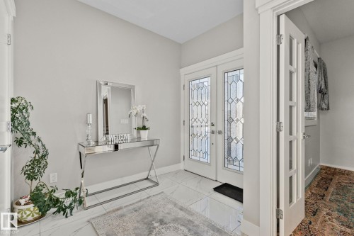 Foyer entrance with french doors and light marble finish flooring - 1611 158 Street, Edmonton, AB - Indoor Photo Showing Other Room