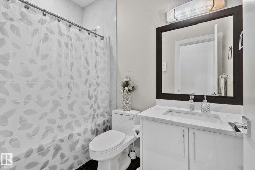Full bath featuring vanity and curtained shower - 1611 158 Street, Edmonton, AB - Indoor Photo Showing Bathroom