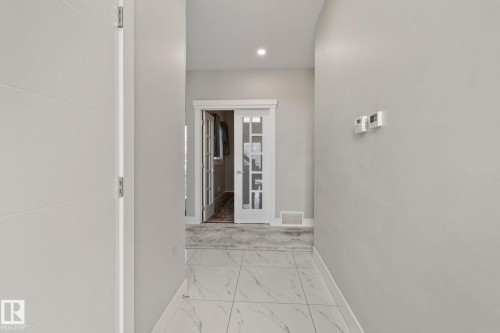 Hallway featuring light marble finish floors and recessed lighting - 1611 158 Street, Edmonton, AB - Indoor Photo Showing Other Room