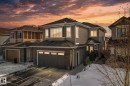 View of front of home featuring a garage, driveway, brick siding, and a shingled roof - 1611 158 Street, Edmonton, AB  - Outdoor 
