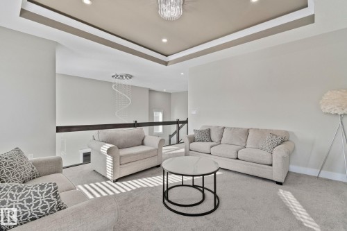 Living room featuring a tray ceiling, carpet flooring, and recessed lighting - 1611 158 Street, Edmonton, AB - Indoor Photo Showing Living Room