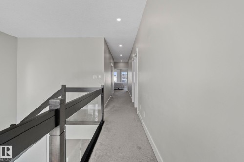 Hall with light carpet, recessed lighting, and an upstairs landing - 1611 158 Street, Edmonton, AB - Indoor Photo Showing Other Room