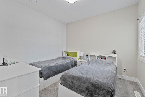 Bedroom with light colored carpet and multiple windows - 1611 158 Street, Edmonton, AB - Indoor Photo Showing Bedroom