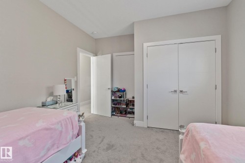 Bedroom featuring light carpet and a closet - 1611 158 Street, Edmonton, AB - Indoor Photo Showing Bedroom