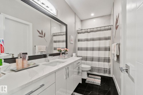 Bathroom with vanity, dark tile patterned flooring, recessed lighting, and shower / tub combo - 1611 158 Street, Edmonton, AB - Indoor Photo Showing Bathroom