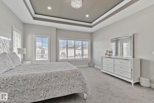 Bedroom with light colored carpet and suspended lighting - 1611 158 Street, Edmonton, AB - Indoor Photo Showing Bedroom