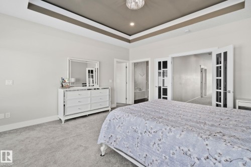Bedroom featuring a raised ceiling, light carpet, and recessed lighting - 1611 158 Street, Edmonton, AB - Indoor Photo Showing Bedroom