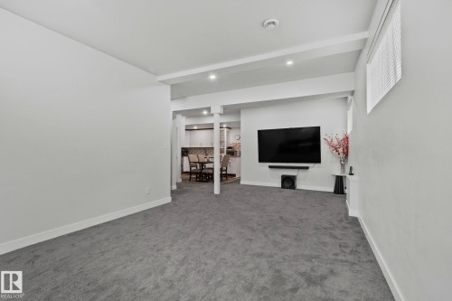 Unfurnished living room featuring carpet floors and recessed lighting - 1611 158 Street, Edmonton, AB - Indoor Photo Showing Other Room
