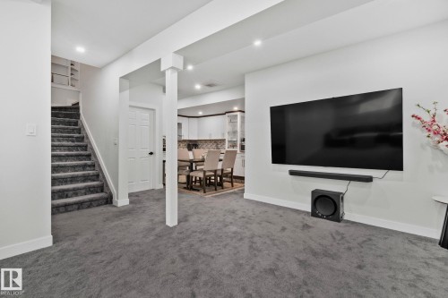 Living area featuring built in features, dark colored carpet, and recessed lighting - 1611 158 Street, Edmonton, AB - Indoor