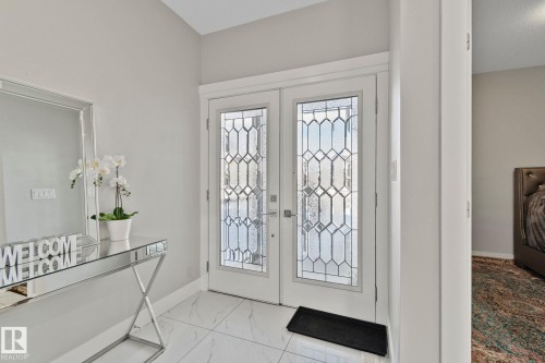 Foyer entrance featuring french doors and light marble finish flooring - 1611 158 Street, Edmonton, AB - Indoor Photo Showing Other Room