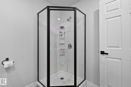Full bath featuring a shower stall and baseboards - 1611 158 Street, Edmonton, AB - Indoor Photo Showing Bathroom