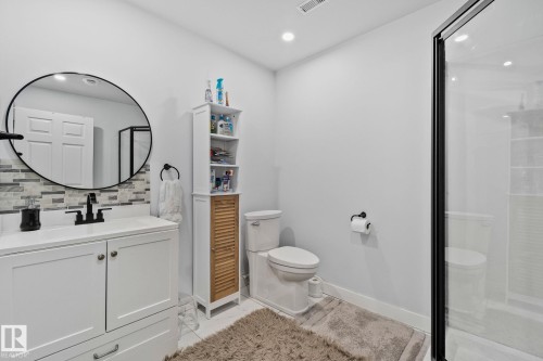 Full bathroom with vanity, a stall shower, recessed lighting, decorative backsplash, and light marble finish floors - 1611 158 Street, Edmonton, AB - Indoor Photo Showing Bathroom